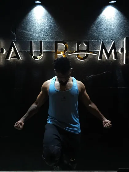 Posing under the gym lights. This shot highlights the upper chest and shoulder pump after a solid push day workout.
