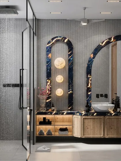 We believe every room deserves to be a sanctuary, including the bathroom. This design features a striking backlit blue marble panel, warm wooden cabinetry, and chevron tiles, blending bold aesthetics with practical features for a serene, spa-like experience at home.