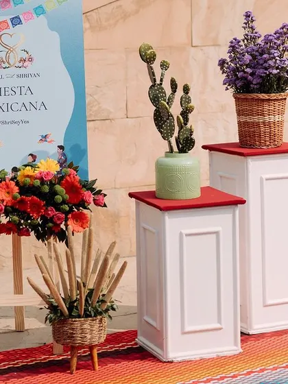 The welcome signage for the 'Fiesta Mexicana', surrounded by colorful flowers and cacti. This sets a fun and festive tone from the moment guests arrive.