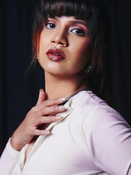 A classic portrait pose that exudes elegance. The lighting is soft and flattering, creating a timeless look.