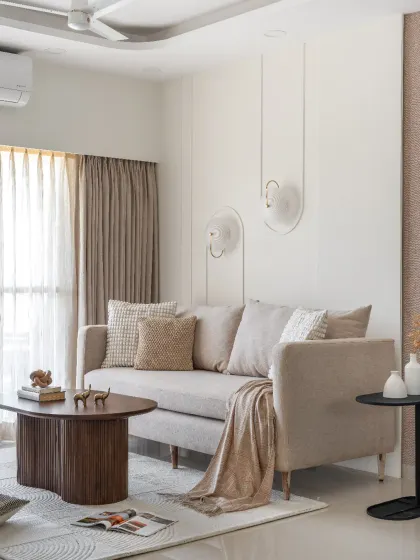 A simple space can be truly elegant. Here, I layered a stylish sofa with unique wall lights, subtle wall trims, and a statement wallpaper to create a cohesive, sophisticated look that embodies the 'less is more' philosophy.