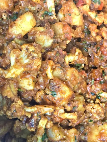 A close-up texture shot of our hearty Aloo Gobi sabzi.