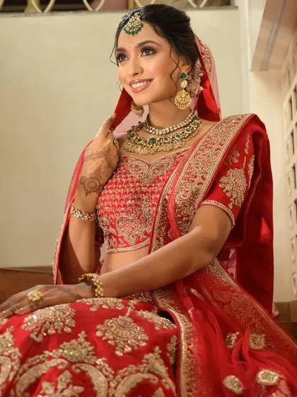 The regal red lehenga, the stunning jewelry, and my mehendi completing the look. This bride is absolutely glowing.