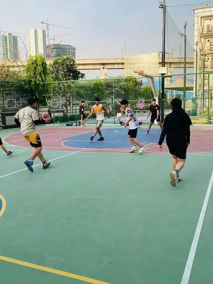 A player dribbles down the court, looking to initiate the offense.