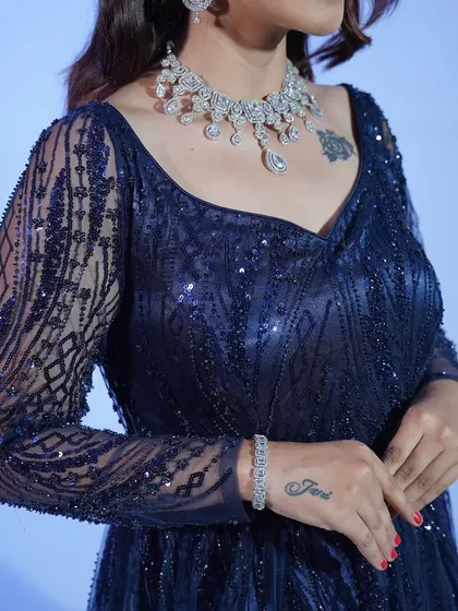 A close-up of the jewelry paired with the midnight blue gown. The right accessories can elevate your rented look to the next level.
