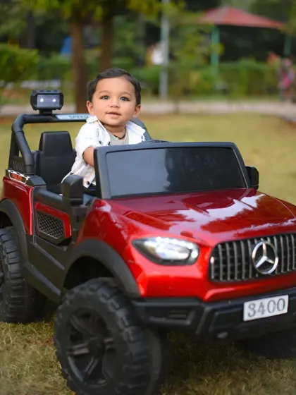 A great portrait of the child in his toy car, capturing his curious and sweet expression.