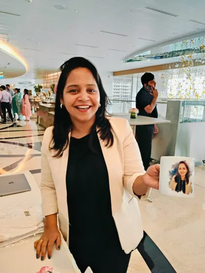 A happy guest holding a coffee mug customized with her digital caricature. This shows an innovative extension of our service, where the artwork can be printed on various merchandise for an even more unique and useful souvenir.