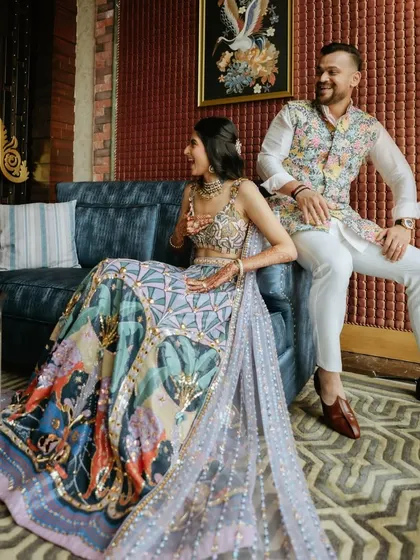 A full-length shot of the couple. The bride's lehenga is a work of art, and I kept the makeup elegant and clean to complement it.