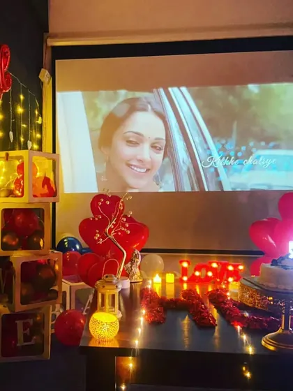 Watching Shershaah on a private screen. A romantic movie night with your partner, surrounded by 'LOVE' decor, is an experience to cherish.