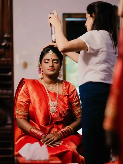 A behind-the-scenes shot of me setting the bride's hair for her Muhurtham. A good setting spray is essential to ensure the hairstyle holds throughout the long ceremony.