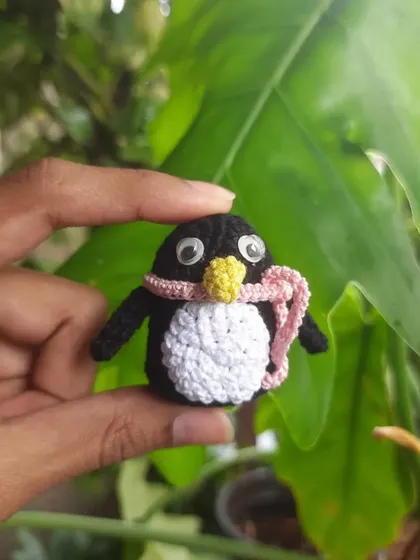 This little penguin is all bundled up in a pink scarf. It's a perfect winter-themed desk buddy or keychain, and the googly eyes give it so much character.