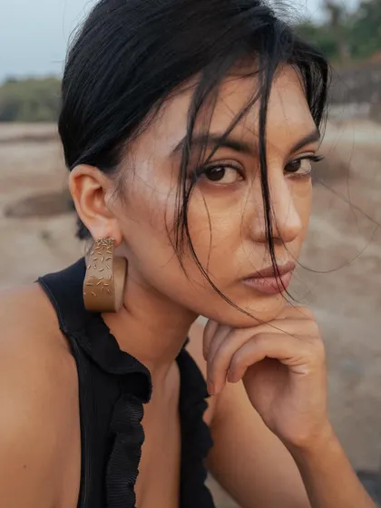 Another portrait from the Noupelle Studio jewelry shoot. The makeup is minimal and the hair is styled with loose, wind-swept pieces to create an effortlessly chic look.