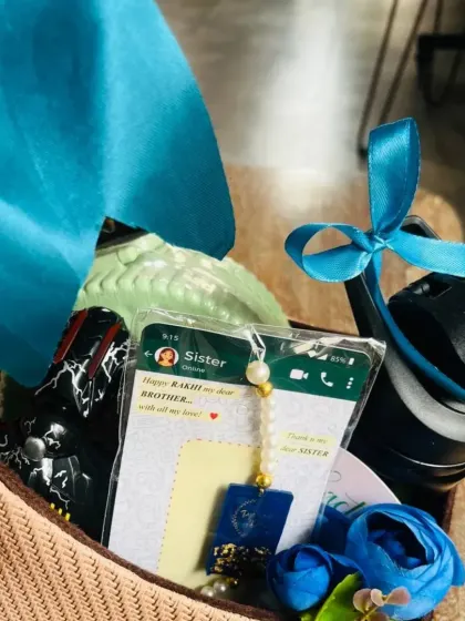 A close-up of a Rakhi hamper for a brother, featuring a personalized rakhi with a screenshot of a sweet message.