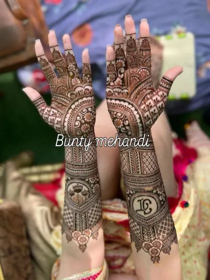 For this design, we incorporated the couple's initials and the scales of justice symbol, which was personally significant to them. I can add any custom element to make your bridal mehandi unique.