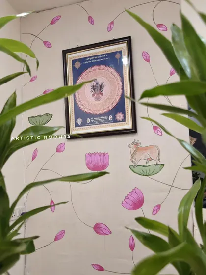 Another angle of the Pichwai mural, peeking through the office plants. The natural elements in the room complement the botanical theme of the painting perfectly.