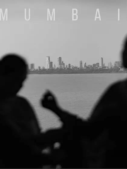 A silhouette of the bride's family getting ready, with the Mumbai skyline in the background. This black and white shot tells a story of place and family.