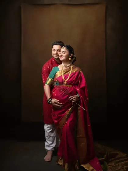 A traditional couple's portrait in a pink saree, full of warmth and love.