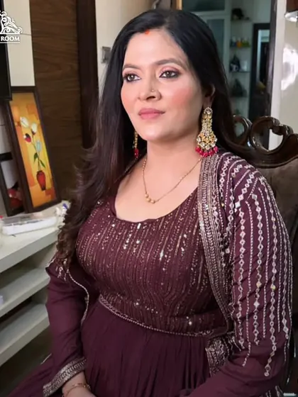 A full view of the client in her chair. The makeup is soft and pretty, suitable for a daytime or evening event.
