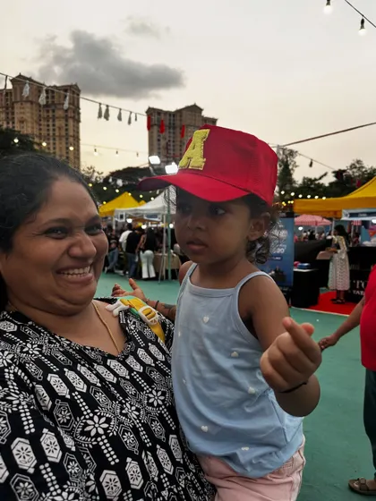 Even the little ones love getting their own personalized caps. This toddler looks adorable in her red cap with an 'A' patch.