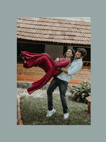 A fun and dynamic shot of the groom lifting his bride in his arms.