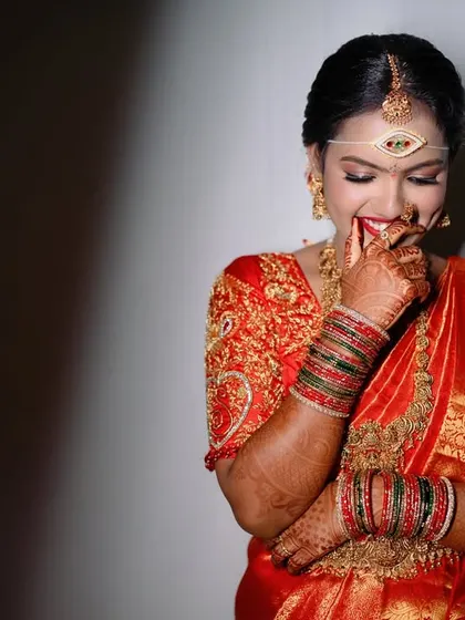 A candid shot of a bride's shy and happy laugh. We love capturing these genuine, unposed expressions.