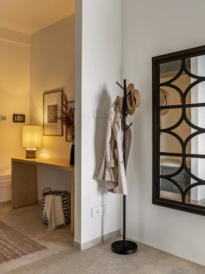 A simple coat rack and a windowpane mirror create a functional and stylish drop-zone in this entryway. It's the small, thoughtful details that make a house a home.