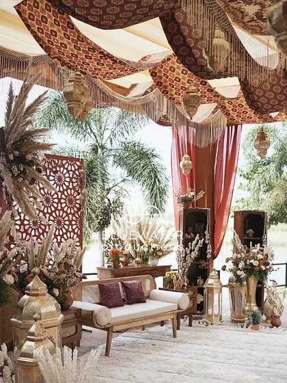 A wider view of the lakeside Mehendi setup, where earthy tones and natural textures blend beautifully with the waterfront view.
