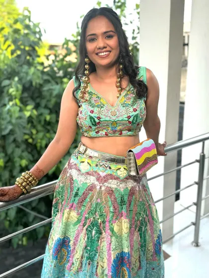 A happy and confident wedding guest, ready to celebrate. The makeup is designed to last all day and night.