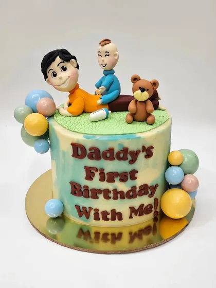 A sweet cake celebrating a dad's first birthday with his baby. The custom fondant topper captures a tender moment between father and son, complete with a little teddy bear.