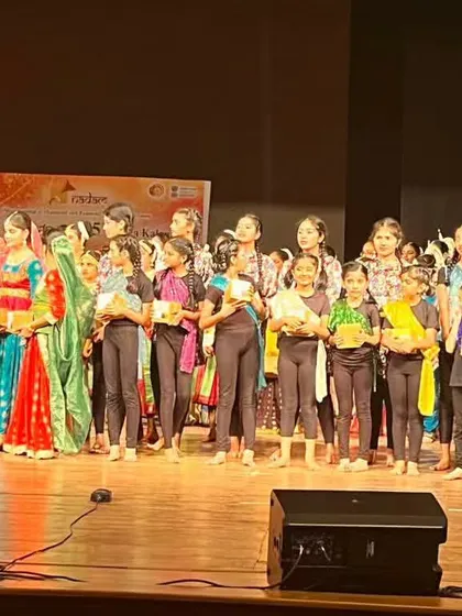 The entire group of junior performers on stage receiving appreciation. It's a rewarding experience for them and for us as teachers.