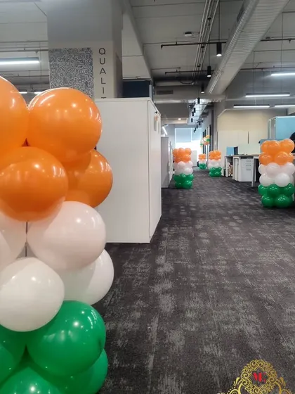 To bring the celebration to every employee, I placed these tricolor balloon pillars along the aisles between workstations at DQS. It's a great way to decorate a large office floor.