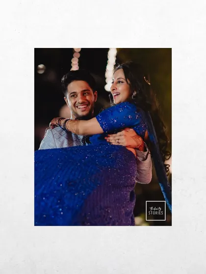 A joyful moment with the groom lifting the bride in his arms. Their happy expressions make this a perfect candid shot from their Sangeet.
