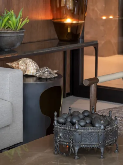 Styling is about creating small, beautiful moments. An antique cast iron brazier, seashells from travels, and a sculptural side table come together to form a composition that is both personal and aesthetically pleasing.