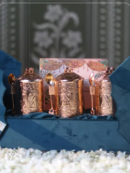 Unveiling the treasures within. This image shows the set of three ornate, gold-finished mukhwaas jars nestled in the elegant blue velvet box, ready to delight your guests.