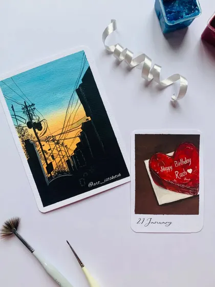 More amazing art from my artist friends in our group collaboration, featuring a cityscape and a heart-shaped cake.