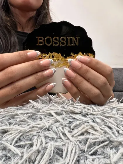 I elevated this classic French manicure by adding a touch of glamour. A delicate layer of gold foil is applied at the tip, creating a beautiful contrast with the clean white line.