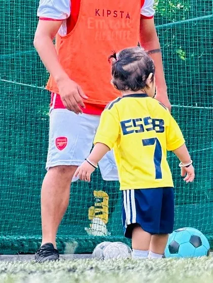 A coach guides one of our smallest players on the field. We provide a safe and encouraging space for toddlers to explore the game.