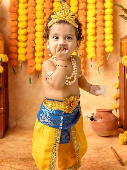 This mischievous little Krishna is caught tasting some butter. These candid moments are what make the photos so special.