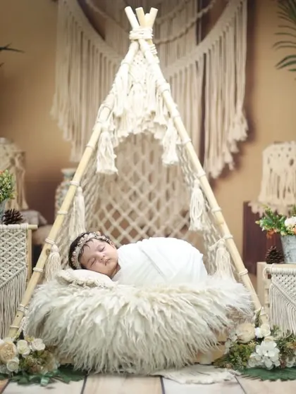 Capturing the essence of bohemian style in a newborn portrait. The combination of textures from the macrame, fur, and florals makes this a truly artistic shot.
