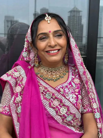 It was so special to get my mother-in-law ready for Mahavir Janamvanchan. I gave her a dewy, celebratory look with a traditional pink outfit that made her smile shine.