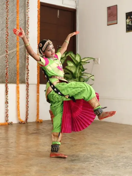 A young dancer performs a dynamic Bharatanatyam piece.