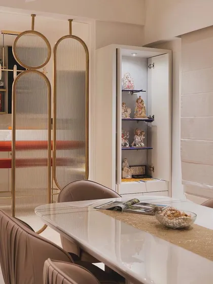 A beautiful shot of the dining area, highlighting the elegant pooja unit and the stylish partition.