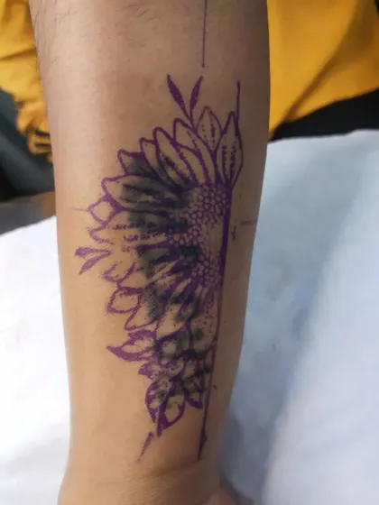The stencil and initial shading for a sunflower cover-up, showing how we build the design to hide the ink underneath.