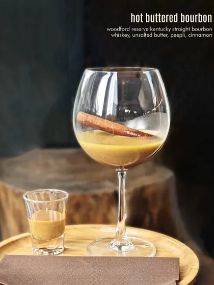 The Hot Buttered Bourbon, a warm and comforting drink with unsalted butter, spices, and bourbon.