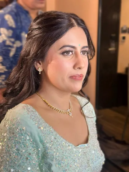 A three-quarter profile showcasing the flawless base and soft contouring. The makeup is designed to look perfect from every angle.