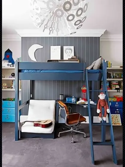 A blue loft bed with a desk and a small sofa underneath, a great all-in-one solution for a teen's room.