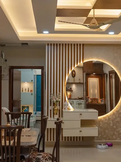 A different perspective of the dining area, highlighting the beautiful wall clock and the seamless integration of the vanity unit, which adds both function and flair.