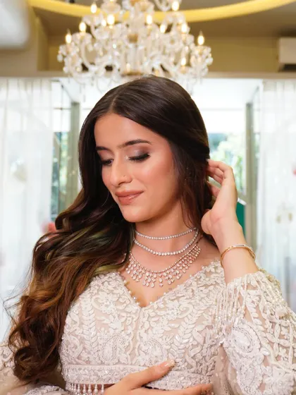 A modern and soft makeup look, perfect for today's bride. This look features soft smokey eyes, glowing skin, and relaxed, wavy hair.