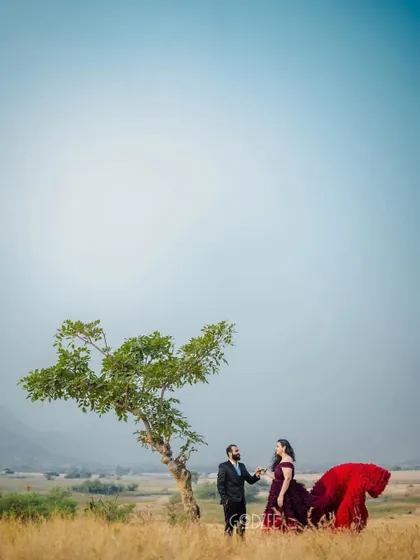 A wide shot that captures the feeling of being in your own world together. The pop of color from the gown against the minimalist landscape is simply stunning.