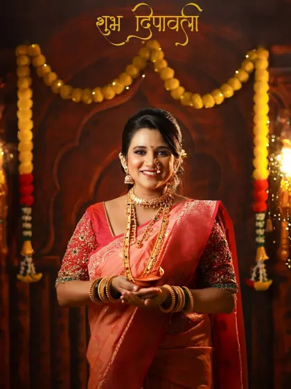 A joyful portrait of a woman in a traditional saree holding a diya, with "Shubh Deepavali" written in Marathi, perfectly capturing the Diwali spirit.